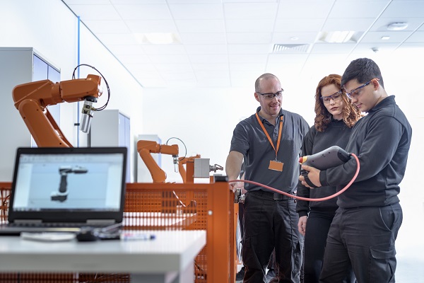 workers receiving training in manufacturing facility